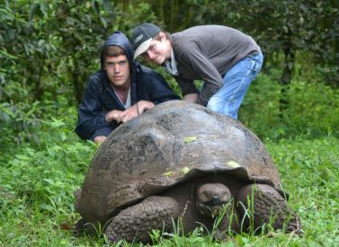 Kids with giant tortoises Family holiday Galapagos