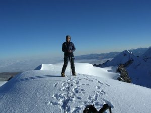 Climber on summit of trekking peak Ausangate Peru