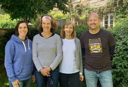 photo of four people smiling