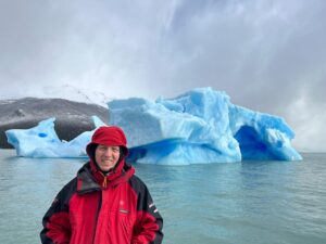 photo of a man in front of large chunks of ice