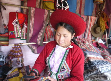 Weaver in traditional dress, Peru